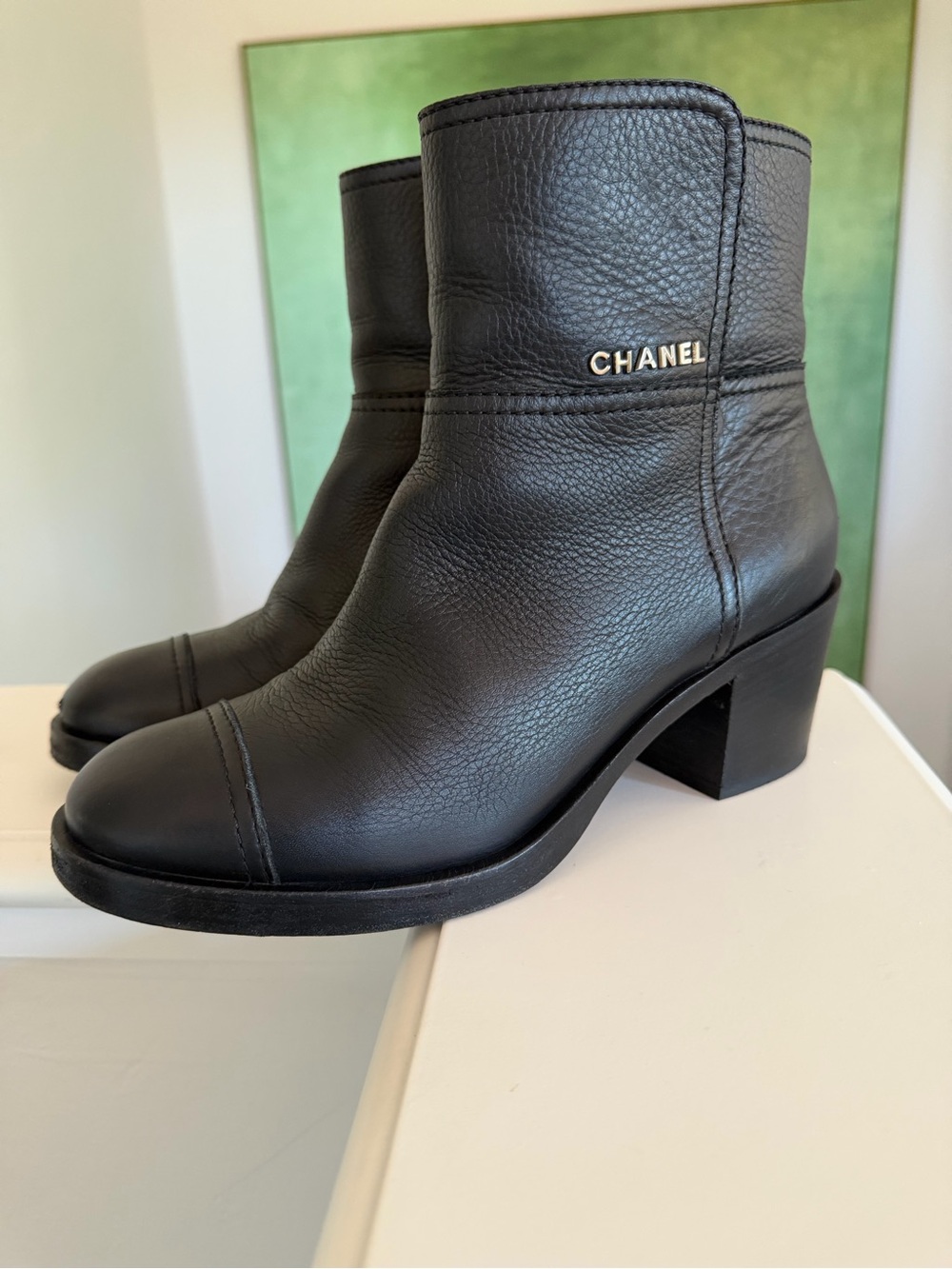 CHANEL Black Leather Ankle Booties with Gold Logo Accent